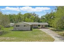 Charming single-story home featuring a well-maintained lawn, carport, and welcoming facade at 2502 Falkner Rd, Orlando, FL 32810