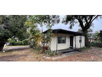 Cozy single-story home featuring neutral paint, mature landscaping and a covered front porch at 3440 S Nashville Ave, Orlando, FL 32839