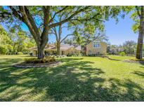 Charming single-Gathering home boasting a spacious lawn and mature trees offering plenty of shade at 40600 Louise Rd, Umatilla, FL 32784