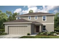 Charming two-story home with a well-maintained lawn, two car garage, and neutral color palette at 4940 Bluebell Ct, Lake Hamilton, FL 33851