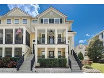 Charming two-story townhome with double porches, stairs, and manicured landscaping at 1169 Orange Ave, Winter Springs, FL 32708