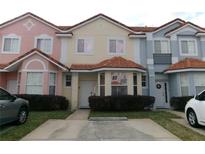 Charming multi-colored townhomes feature tile roofs and well-maintained landscaping, creating curb appeal at 1285 S South Beach Circle Cir, Kissimmee, FL 34746