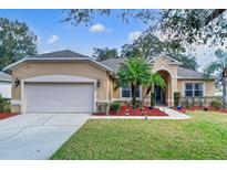 Charming single-story home featuring a manicured lawn, complemented by a two-car garage at 1913 Lazy Oaks Loop, St Cloud, FL 34771