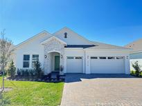 Charming single-story home featuring a stone facade, a paver driveway, and a three-car garage at 2010 Divot Dr, Daytona Beach, FL 32124