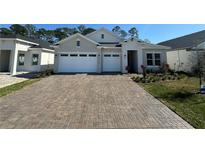 Charming single-story home with a two-car garage and a beautifully paved driveway at 3108 Firethorn Cir, Daytona Beach, FL 32124