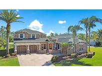Beautiful two-story home featuring a three car garage, manicured landscaping, and a paver driveway at 3890 Mcguirk Ct, Oviedo, FL 32766