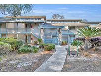 Inviting condo building with well-maintained landscaping and exterior stone accents near the entrance at 5036 Sherwood Ln # 3945-6, Haines City, FL 33844