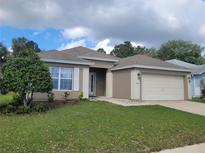 Charming single-story home boasts well-maintained landscaping and an attached two-car garage at 5523 Sw 42Nd Pl, Ocala, FL 34474