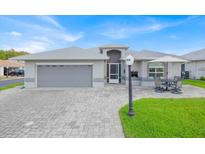 Charming single-story home featuring a two-car garage, paved driveway, and well-maintained lawn at 704 Pinnacle Dr, Haines City, FL 33844