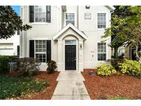 Inviting front entrance with a black door, well-maintained landscaping, and a clear address display at 9117 Lee Vista Blvd # 603, Orlando, FL 32829