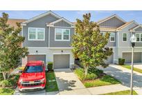 Charming townhome features a well-maintained front yard, gray siding, and attached garage in a desirable neighborhood at 9161 Shepton St, Orlando, FL 32825
