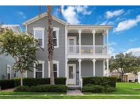 Charming two-story home featuring a double porch, well-maintained landscaping, and a welcoming facade at 1552 Fairview Cir, Reunion, FL 34747