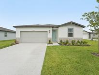Charming one-story home with a well-manicured lawn and a light-blue front door at 2105 Rosewood Dr, Bartow, FL 33830
