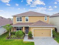 Lovely two-story home with a well-maintained lawn and an attached two-car garage at 211 Lazio Cir, Debary, FL 32713