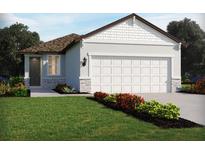 Charming single-Gathering home featuring a two-car garage and beautifully landscaped front yard with colorful flower beds at 2514 Linda Knoll Ln, Bartow, FL 33830