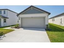 Attached two-car garage featuring a concrete driveway and neutral color palette at 2514 Linda Knoll Ln, Bartow, FL 33830