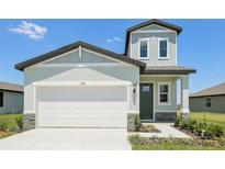 Charming two-story home featuring a two-car garage, light-colored exterior, and a well-manicured lawn at 2515 Linda Knoll Ln, Bartow, FL 33830