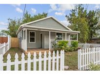 Charming home featuring a quaint porch, a well-manicured lawn, and a white picket fence at 2807 S Brown Ave, Orlando, FL 32806