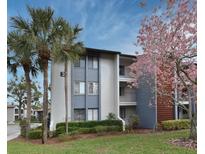 Well-maintained condo building featuring a charming architectural design and colorful landscaping at 3 Escondido Cir # 3, Altamonte Springs, FL 32701
