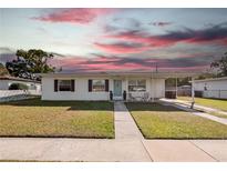 Charming single-story home with a well-maintained lawn and covered front entrance at 7108 Stockholm Way, Orlando, FL 32822