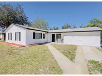 Charming single-story home with a well-maintained yard, black shutters and a walkway leading to the front door at 1762 Philadelphia Ct, Deltona, FL 32725