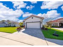 Charming single-Gathering home featuring a well-manicured lawn and a two-car garage at 2400 Symphony Cir, St Cloud, FL 34771