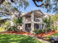 Inviting two-story condo featuring a screened porch and balcony, nestled in a lush, landscaped community at 2533 Grassy Point Dr # 113, Lake Mary, FL 32746