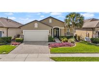 Charming single-story home with brick paved driveway and meticulously manicured landscaping at 846 Asturias Rd, Davenport, FL 33837