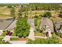Aerial view of a well-maintained property, surrounded by lush greenery and a golf course at 229 Troon Cir, Davenport, FL 33897