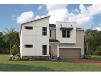 Modern two-story home featuring a two-car garage, and a well-manicured lawn surrounded by lush greenery at 2338 Sea Rock Rose Trl, Kissimmee, FL 34747