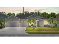 Charming single-story home with a well-manicured lawn, three-car garage and complemented by swaying palm trees at 2501 Hinsdale Dr, Kissimmee, FL 34741