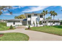 Stunning modern home with unique architectural details, mature landscaping and a circular driveway at 409 W 2Nd Ave, Windermere, FL 34786
