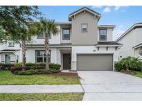 Charming two-story home with a two-car garage and well-maintained landscaping at 418 Marcello Blvd, Kissimmee, FL 34746