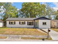 Charming single-story home featuring a well-maintained lawn and classic architectural details at 5603 Marie Ct, Orlando, FL 32818