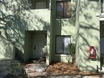 Exterior view of the building with stairs, front door, windows and a red fire hose cabinet at 5855 La Costa Dr # S, Orlando, FL 32807