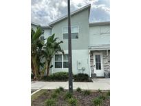 Two-story townhome showcases modern architecture, lush landscaping, and a welcoming front door at 8008 Formosa Valley Pl, Kissimmee, FL 34747