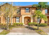 Inviting two-story home with a well-manicured lawn and charming architectural details at 122 Capri Dr, Davenport, FL 33897