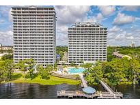 Stunning view of two high-rise buildings and waterfront amenities including a pool and dock with lake access at 13427 Blue Heron Beach Dr # 103, Orlando, FL 32821