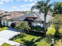 Beautiful one-story home featuring mature landscaping, a well-manicured lawn, and a private driveway at 2258 Crystal Falls Way, Orlando, FL 32824