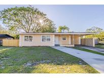 Charming single-story home with a covered carport and well-maintained front lawn at 4320 Meadowbrook Ave, Orlando, FL 32808