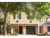 Charming two-story home featuring a well-maintained lawn, black door with wreath, and an attached garage at 5020 Ashford Falls Ln, Oviedo, FL 32765