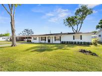 Charming single-story home with a well-manicured lawn and classic black and white color scheme at 536 Ellerbe Way, Lakeland, FL 33801