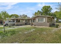 Charming single-story home with a partially covered driveway and spacious yard at 941 Grey Oak Ct, Orlando, FL 32809