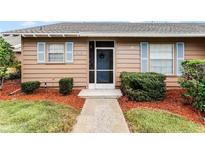 Charming home entrance featuring a screen door, tidy landscaping, and light blue shutters at 1234 Villa Ln # S, Apopka, FL 32712