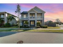 Charming two-story home featuring dual balconies, manicured lawn and lush landscaping for great curb appeal at 12849 Bovet Ave, Orlando, FL 32827