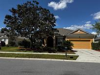 Charming single-story home with a well-manicured lawn and a two-car garage at 2705 Treymore Dr, Orlando, FL 32825