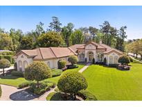 Stunning exterior with lush lawn, manicured landscaping, and a beautiful tile roof at 401 Timberwalk Ln, Lake Mary, FL 32746