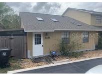 Cozy single-story home with a neatly maintained front entrance and grey shingle roof at 4655 Lighthouse Cir # 117, Orlando, FL 32808