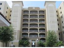 Spacious condominium featuring balconies with wrought-iron railings and lush landscaping at 6336 Buford St # 602, Orlando, FL 32835