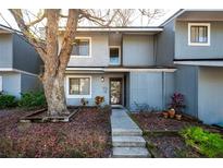 Charming gray two-story townhome featuring a well-maintained yard and inviting entryway at 710 Saint Matthew Cir # 710, Altamonte Springs, FL 32714